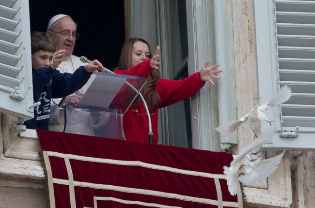 Papa Francesco con i bambini che fanno volare le colombe